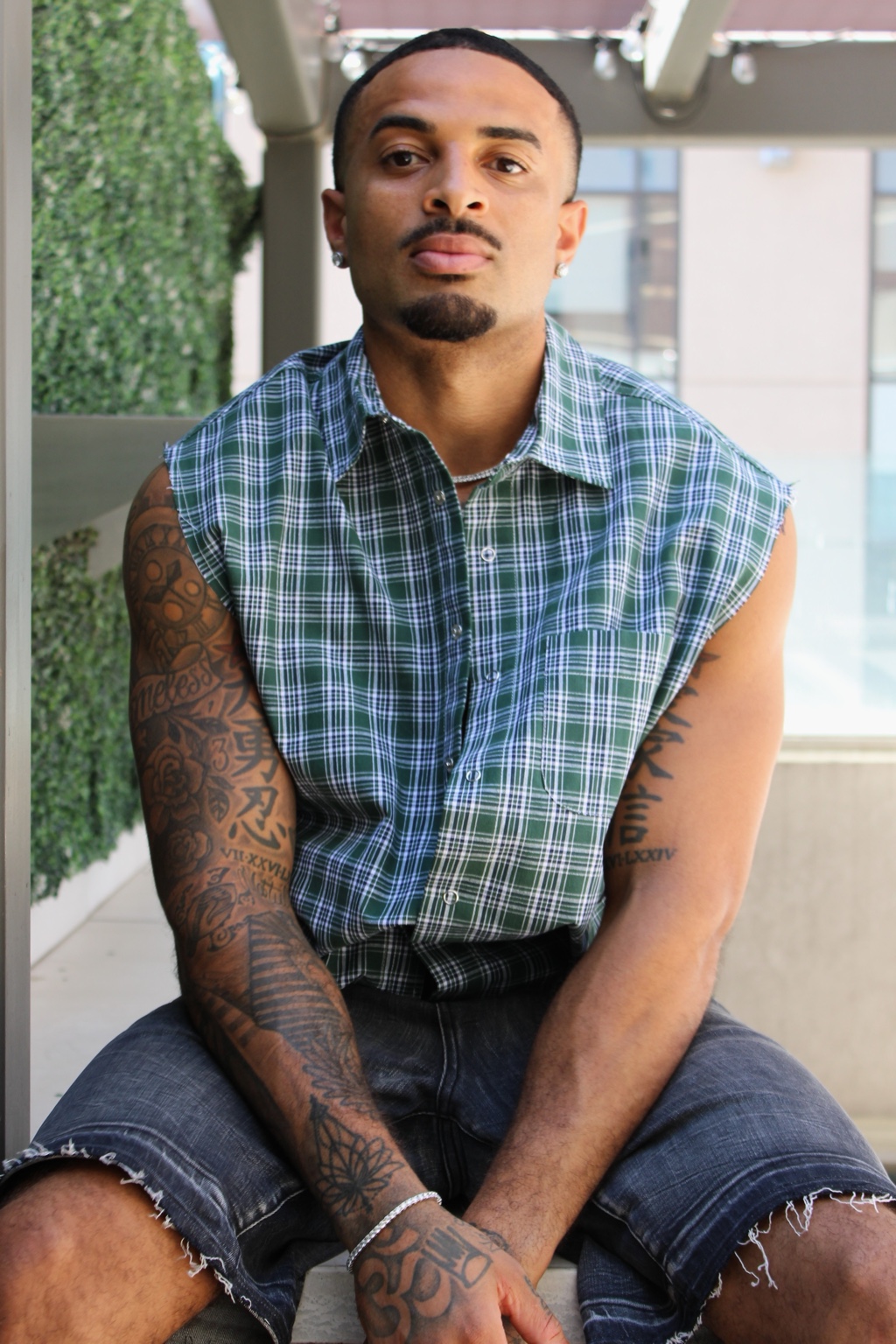 James Muhammad commercial portrait in green plaid sleeveless shirt