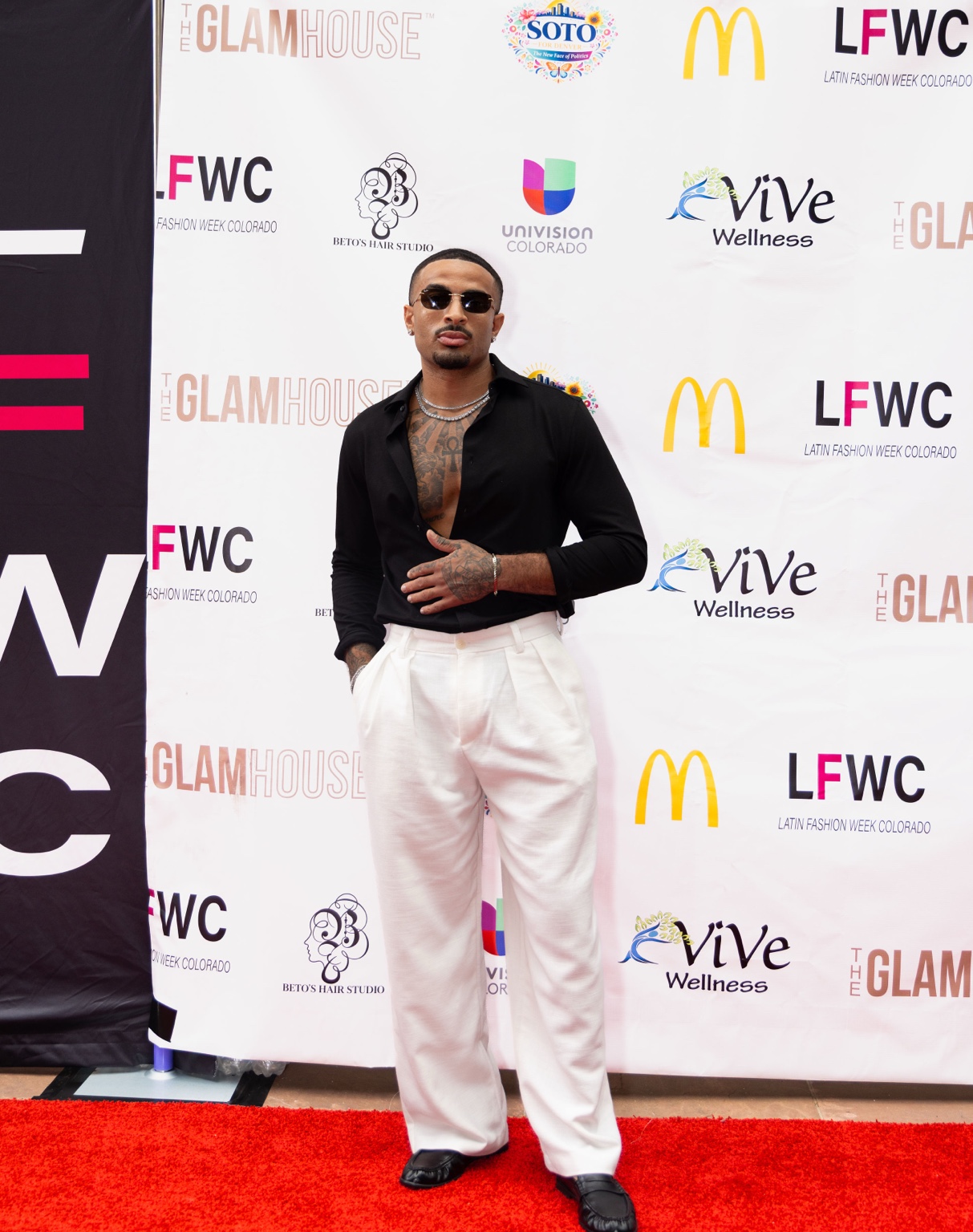 James Muhammad posing at Latin Fashion Week Colorado red carpet