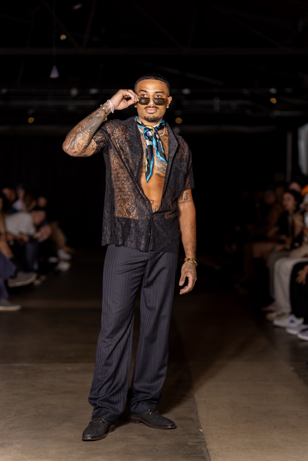 James Muhammad runway model in black lace shirt and scarf